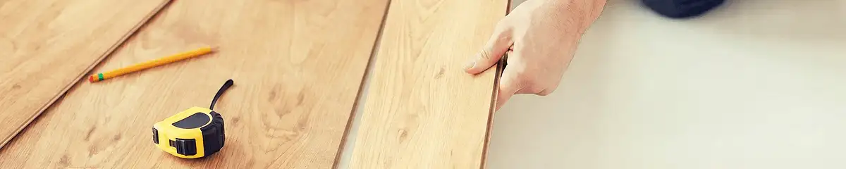 A professional installing wood flooring in Knoxville, TN