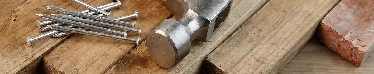 Hammer and nails on hardwood flooring boards in Knoxville, TN