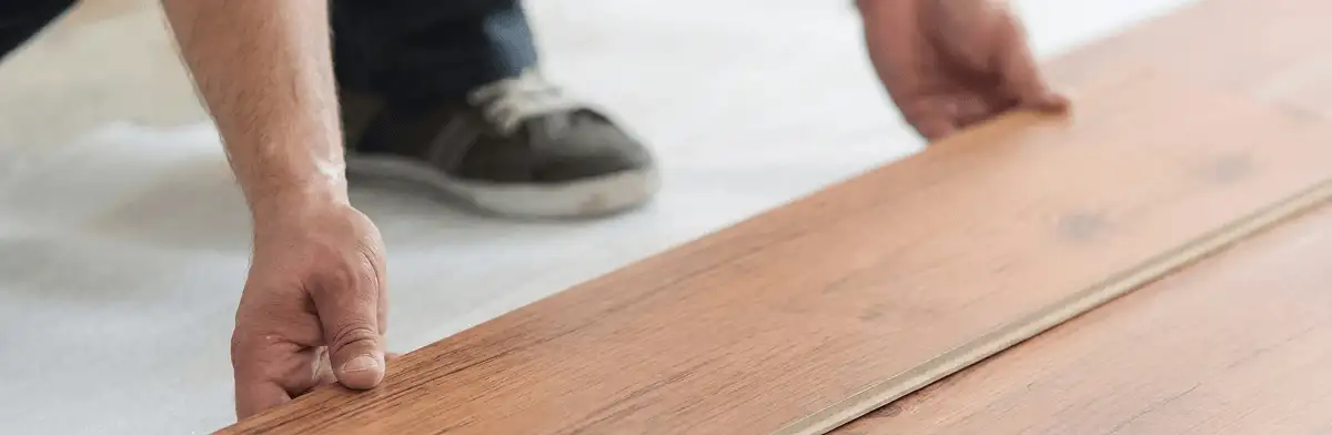 A professional installing laminate flooring in Knoxville, TN